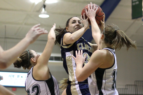 Photo by Ethan Magoc: Mercyhurst College seniors Samantha Loadman (right) and Amy Achesinski defend Clarion University&amp;#039;s Mackenzie Clark during the first half on Wednesday, Jan. 19, 2011, at the Mercyhurst Athletic Center. Loadman registered a block on the play.
